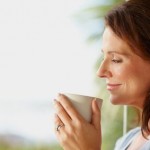 Happy woman holding a coffee cup