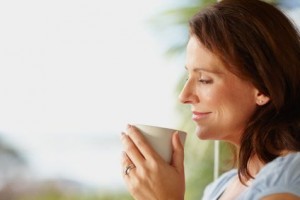 Happy woman holding a coffee cup