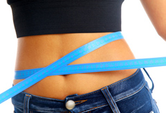 Measure tape around slim beautiful waist.